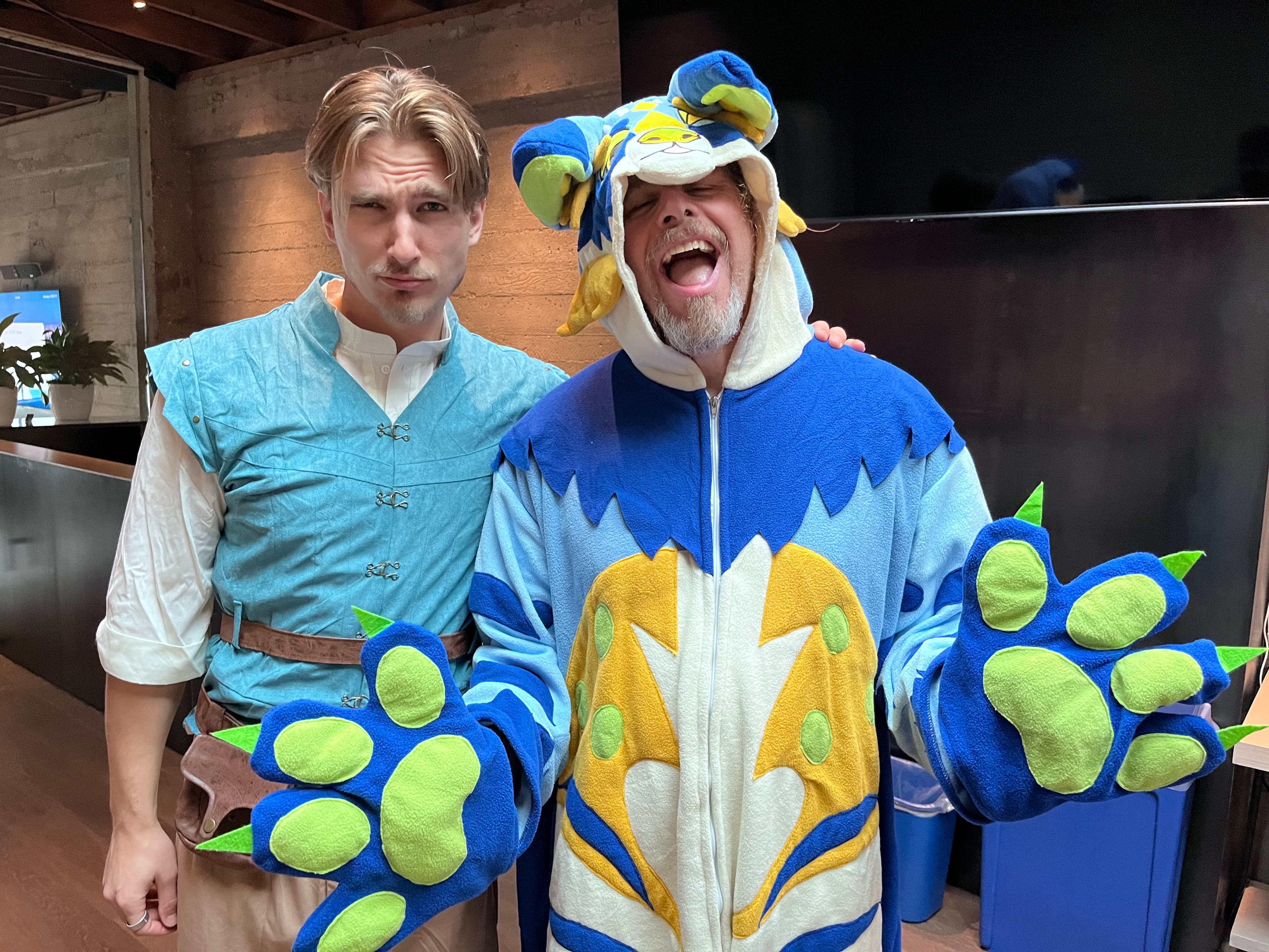 Anon teammates in costume at an office gathering.